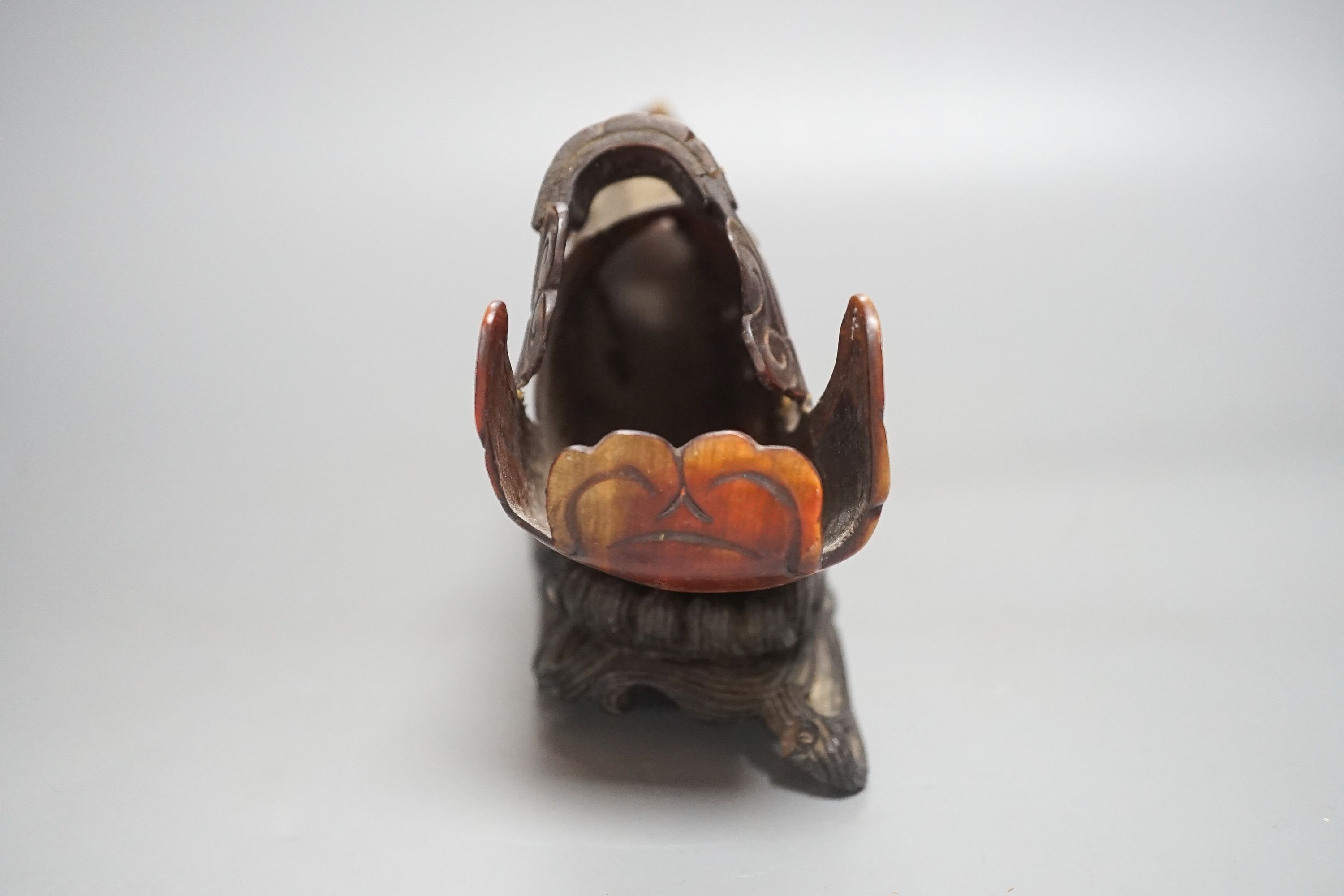 A Chinese horn carving of a junk boat, wood stand, 34cm